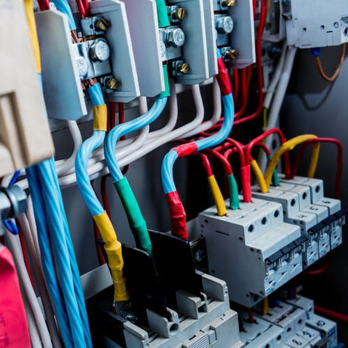 Wires and switches in electric box. Electrical panel with fuses and contactors. Background and texture