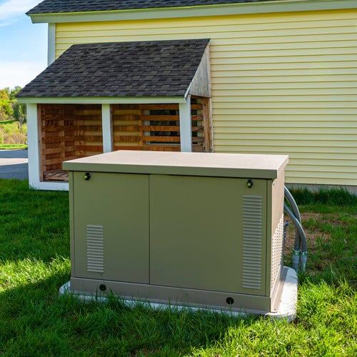 Residential standby generator at the house wall