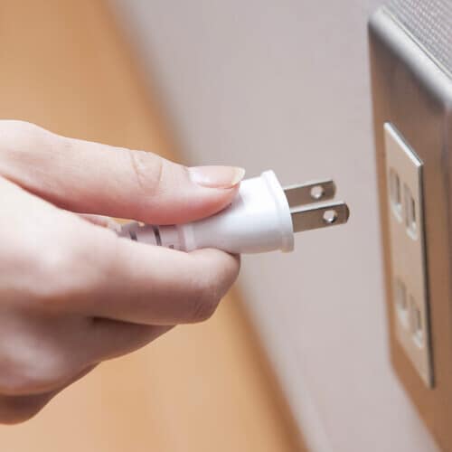 placing a plug in an electrical outlet