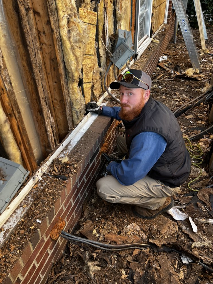 taking care of a leak along the side of an apartment