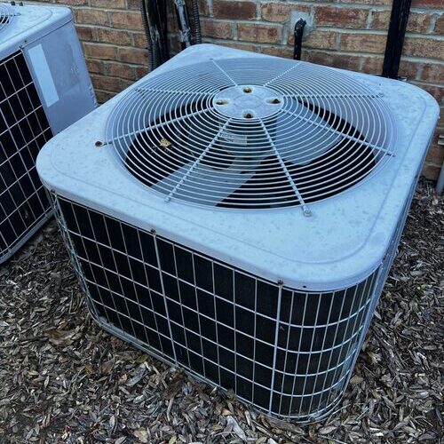 AC compressor sitting outside a house
